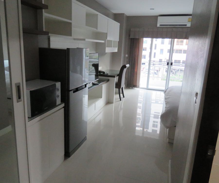 view of my studio rental - microwave, refriderator, AC, desk, large screen TV.